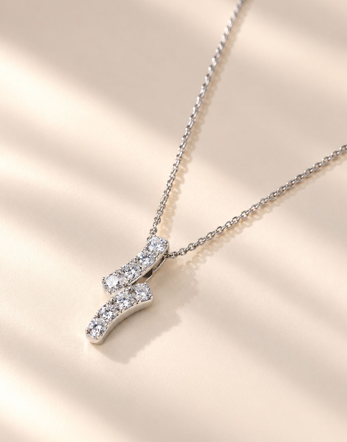 Elegantdiamondpendantonivorysurface